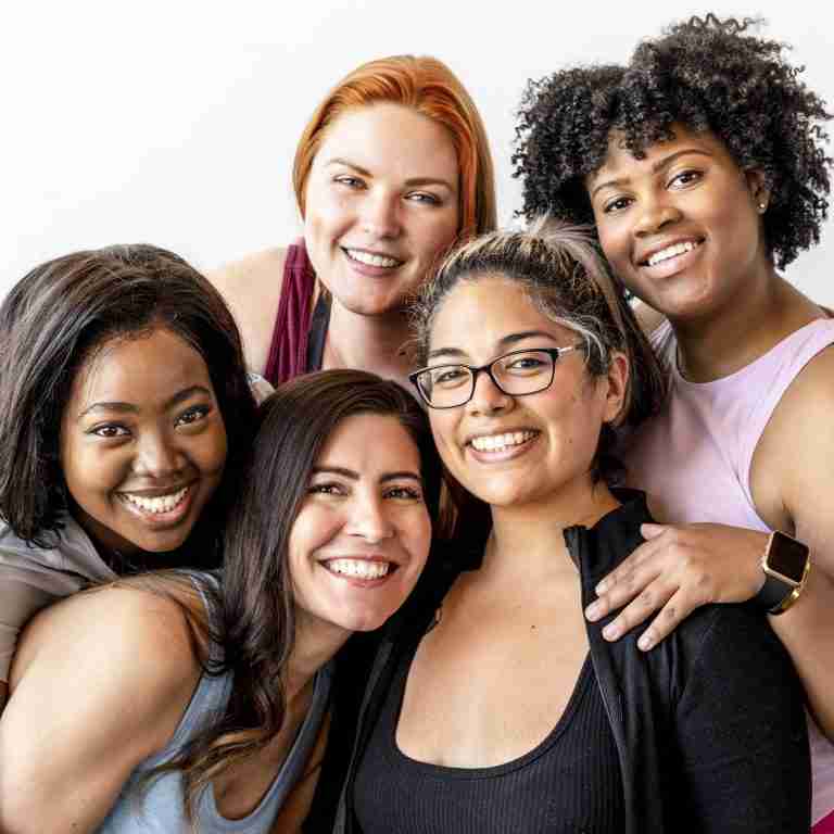 Happy female workout team at the gym