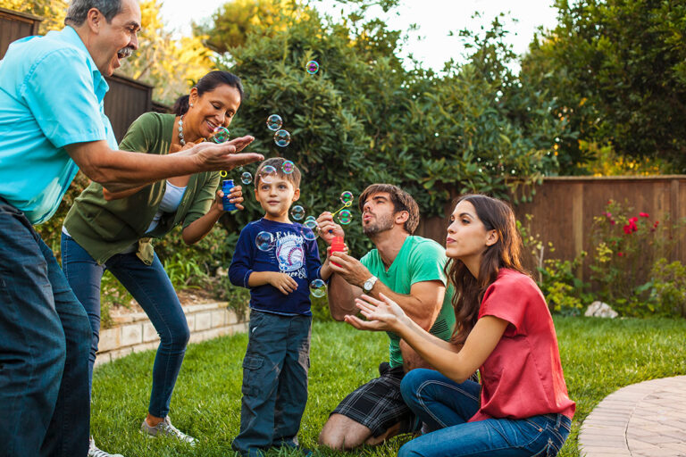 three-generation-family-blowing-bubbles-in-garden-2025-04-03-04-55-43-utc